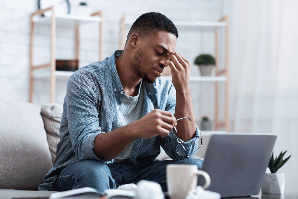 man using computer and looking uncomfortable