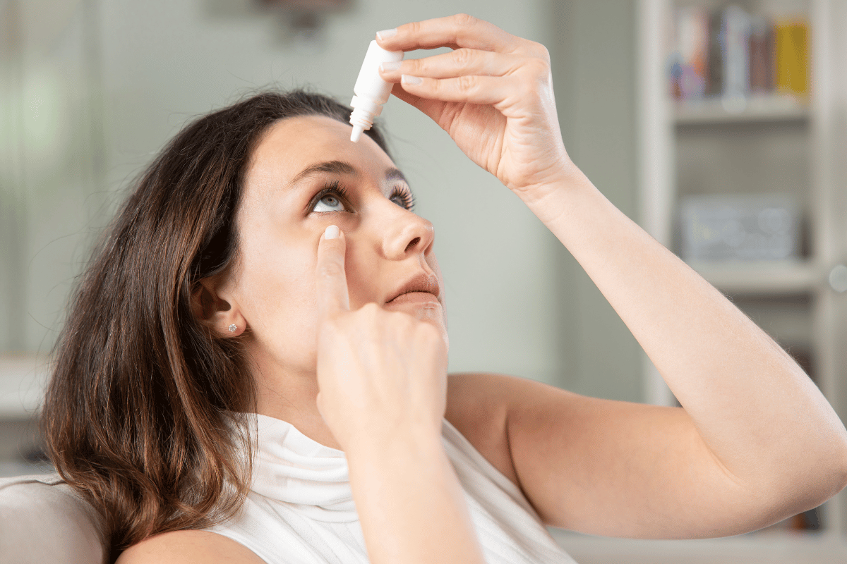 a woman putting in eye drops