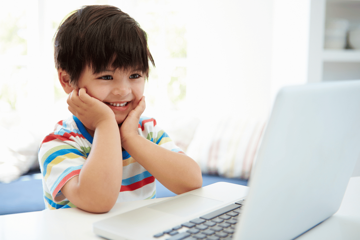 a little boy using a computer