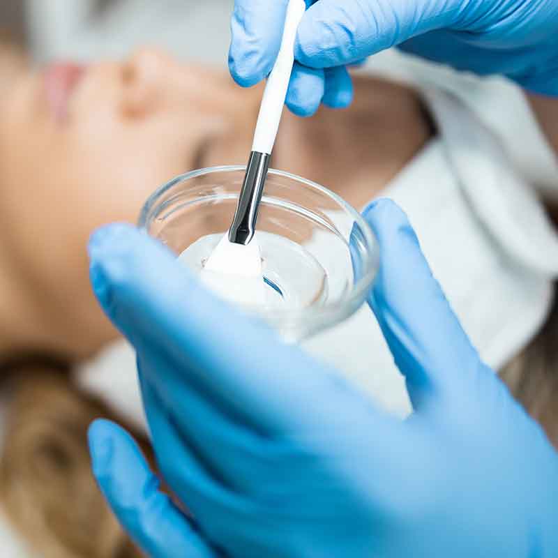 a professional applying wax for leg hair removal